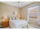 Cozy bedroom with brass bed frame, side tables, and bright natural light at 4961 Sabal Lake Cir, Sarasota, FL 34238