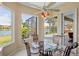 Bright breakfast nook featuring large windows with water views and a round glass table at 4961 Sabal Lake Cir, Sarasota, FL 34238
