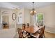 Charming dining area with a traditional chandelier and views of the front entrance at 4961 Sabal Lake Cir, Sarasota, FL 34238