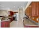 Well-lit kitchen with stainless steel appliances, granite countertops, and ample cabinet space at 4961 Sabal Lake Cir, Sarasota, FL 34238