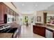 Modern kitchen featuring granite countertops, stainless steel appliances, and a breakfast nook with lake views at 4961 Sabal Lake Cir, Sarasota, FL 34238