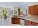 Open kitchen with granite countertops, stainless appliances, and a view to the outdoor patio at 4961 Sabal Lake Cir, Sarasota, FL 34238