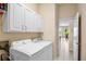 Bright laundry room with white cabinets, washer, dryer, and tile floors at 4961 Sabal Lake Cir, Sarasota, FL 34238