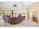 Spacious living room showcasing a leather sofa, tile floors, and scenic lake views at 4961 Sabal Lake Cir, Sarasota, FL 34238