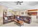 Bright living room with a spacious sectional sofa, leading into the dining and kitchen areas at 4961 Sabal Lake Cir, Sarasota, FL 34238