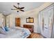 Bright main bedroom with hardwood floors, stylish decor, and access to private balcony at 4961 Sabal Lake Cir, Sarasota, FL 34238