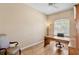 Home office with hardwood floors, a desk, and built in shelving at 4961 Sabal Lake Cir, Sarasota, FL 34238