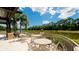 Outdoor seating area overlooking the lake with a fountain at 4961 Sabal Lake Cir, Sarasota, FL 34238