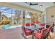 Inviting screened patio with dining area overlooking the pool and lake, offering a perfect spot for relaxation at 4961 Sabal Lake Cir, Sarasota, FL 34238