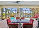 Relaxing screened patio with dining area overlooking pool and picturesque lake, perfect for outdoor entertainment at 4961 Sabal Lake Cir, Sarasota, FL 34238