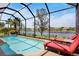 Inviting screened-in pool and lounge chairs overlooking a serene lake, creating a perfect outdoor retreat at 4961 Sabal Lake Cir, Sarasota, FL 34238