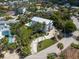 Expansive aerial view of a property with a pool, meticulous landscaping, and a winding driveway at 497 Island Cir, Sarasota, FL 34242