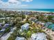 An aerial view captures the home's private pool, backyard and proximity to the beach at 497 Island Cir, Sarasota, FL 34242