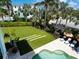 Beautiful backyard featuring a well-maintained lawn, landscaping, pool, and lounge chairs for outdoor relaxation at 497 Island Cir, Sarasota, FL 34242