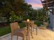 A quaint backyard patio offers a peaceful retreat, ideal for intimate outdoor dining and relaxation at 497 Island Cir, Sarasota, FL 34242