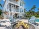 Beautiful backyard with a fire pit, outdoor furniture, and a partial view of the pool at 497 Island Cir, Sarasota, FL 34242