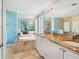 Luxurious bathroom with dual sinks, a soaking tub, and a separate glass-enclosed shower at 497 Island Cir, Sarasota, FL 34242