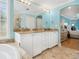 Bright bathroom with double vanity, marble countertop, and tiled floors at 497 Island Cir, Sarasota, FL 34242