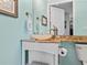 Bathroom with a sink, countertop, and turquoise blue walls at 497 Island Cir, Sarasota, FL 34242