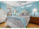 Inviting bedroom with a floral patterned quilt, side tables, and blue accents at 497 Island Cir, Sarasota, FL 34242