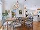 Bright dining room features stylish chairs, wooden floors, and natural light, creating an inviting atmosphere at 497 Island Cir, Sarasota, FL 34242