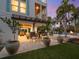 Stunning home with a large outdoor seating area, outdoor kitchen, firepit, spiral staircase, and lush landscaping at 497 Island Cir, Sarasota, FL 34242