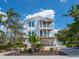 Charming two-story home with a front yard and tropical landscaping at 497 Island Cir, Sarasota, FL 34242