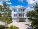 Charming two-story home with a front yard and tropical landscaping at 497 Island Cir, Sarasota, FL 34242
