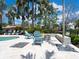 Outdoor seating area with comfortable Adirondack chairs around a fire pit at 497 Island Cir, Sarasota, FL 34242