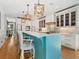 Bright kitchen with a large island, hardwood floors and designer light fixtures at 497 Island Cir, Sarasota, FL 34242