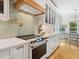 Kitchen with stainless steel appliances, light countertops, and tiled backsplash at 497 Island Cir, Sarasota, FL 34242