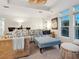 Cozy living room with a wicker sofa, patterned cushions, and a comfortable ottoman at 497 Island Cir, Sarasota, FL 34242