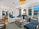 Bright living room featuring stylish furnishings, including a white sofa and blue accent pillows, complemented by modern lighting at 497 Island Cir, Sarasota, FL 34242