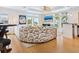 Bright living room featuring a large sectional sofa, wood floors, and large windows with outside views at 497 Island Cir, Sarasota, FL 34242