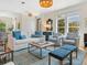 Bright living room featuring stylish furniture, including a white sofa with blue pillows, and elegant decor at 497 Island Cir, Sarasota, FL 34242
