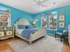 Coastal bedroom featuring blue walls, white furniture, and ample natural light at 497 Island Cir, Sarasota, FL 34242