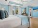 Comfortable main bedroom with a plush bed, dresser, and windows offering serene views at 497 Island Cir, Sarasota, FL 34242