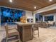 Beautiful outdoor living area with summer kitchen, pool, fire pit and spiral staircase to the home's upper level at 497 Island Cir, Sarasota, FL 34242