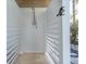 A private outdoor shower with white wood paneling offers convenience and style at 497 Island Cir, Sarasota, FL 34242