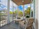 Screened patio featuring comfortable wicker seating and outdoor views at 497 Island Cir, Sarasota, FL 34242