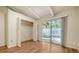 Bedroom includes laminate flooring, vaulted ceilings, closet space, and sliding door access to the backyard at 500 N Jefferson Ave # 5, Sarasota, FL 34237