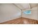 The room is bright with wood floors, vaulted ceilings, a window overlooking the fenced yard, and neutral-colored walls at 500 N Jefferson Ave # 5, Sarasota, FL 34237