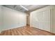 Bright bedroom featuring hardwood floors, white walls, and closet at 500 N Jefferson Ave # 5, Sarasota, FL 34237