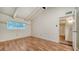 Bright bedroom features vaulted ceiling, wood-look floors, neutral walls, and a window looking into the fenced backyard at 500 N Jefferson Ave # 5, Sarasota, FL 34237