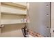 Organized utility closet featuring shelving for storage, including paint cans and hardware at 500 N Jefferson Ave # 5, Sarasota, FL 34237