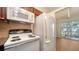 This kitchen showcases a microwave, range, and refrigerator, complemented by wood cabinetry and views of the outdoor patio at 500 N Jefferson Ave # 5, Sarasota, FL 34237