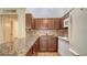 Compact kitchen with granite countertops and white appliances at 500 N Jefferson Ave # 5, Sarasota, FL 34237