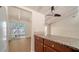 Bright kitchen featuring granite countertops, a ceiling fan, and an adjacent dining area with sliding glass doors to the patio at 500 N Jefferson Ave # 5, Sarasota, FL 34237