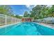 Community swimming pool, chairs, and lifeguard floatation device at 500 N Jefferson Ave # 5, Sarasota, FL 34237