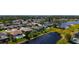Aerial neighborhood view highlights a home’s screened-in patio, a nearby pool, and its proximity to a large lake at 5022 46Th W St, Bradenton, FL 34210